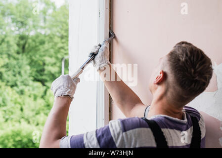 Process male worker repairing window in house, close up Stock Photo