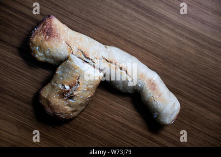 Two pieces of home made, white flour bread over a wooden table in Mutilva, Spain.  Zenith view Stock Photo