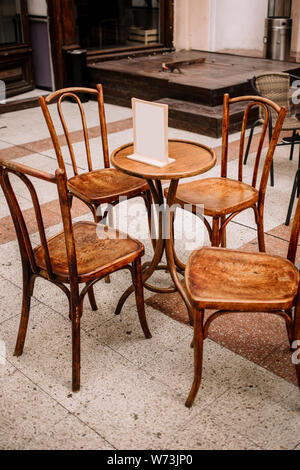 View of empty outdoor cafe. focus on the table. Empty wooden table at an outdoor restaurant. Stock Photo