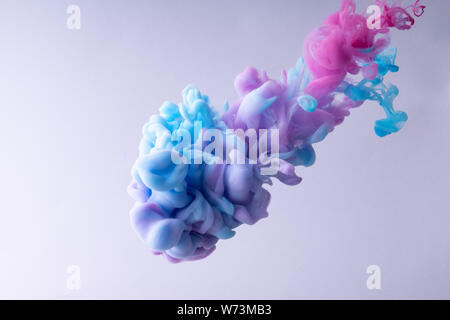 Colorful Ink swirling in water. Cloud of silky ink on white background. underwater. Stock Photo