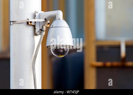 Modern CCTV camera on sky background. Concept of surveillance and monitoring. Stock Photo