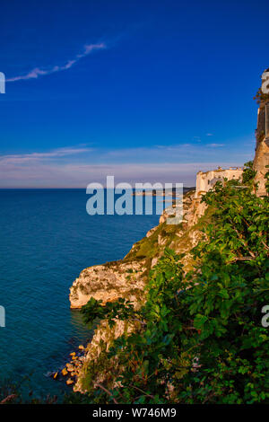 View from the town of Peschici on the rocky coast of the Adriatic Sea in sunset, Gargano Peninsula, Italy Stock Photo
