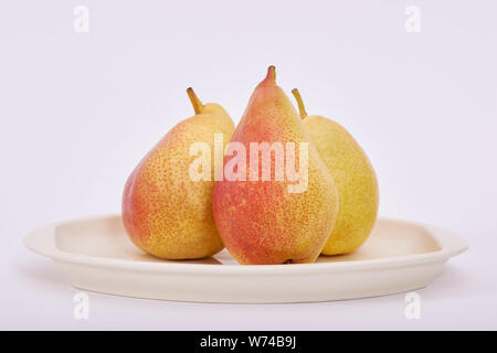 Three Pears in a tray on a white background Stock Photo