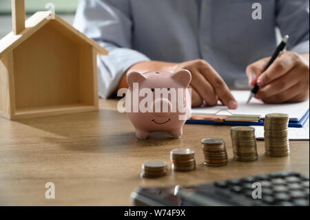 The concept of home ownership Business people negotiating a contract This is where you need to sign Stock Photo