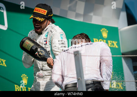 Mercedes AMG Petronas F1 Team’s chief strategist James Vowles and British driver Lewis Hamilton (L) celebrate after winning the Hungarian F1 Grand Prix at Hungaroring. Stock Photo