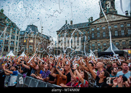 Amsterdam, Netherlands. 04th Aug, 2019. People are seen having fun while canons releases confetti during the performance of Netta. 2018 Eurovision Winner Representing Israel Netta, gave a performance during the final concert of the Pride Amsterdam at the Dam square, in the center of the city. On Sunday, the official end - party, where there is always a colourful collection of artists enters the stage. Credit: SOPA Images Limited/Alamy Live News Stock Photo