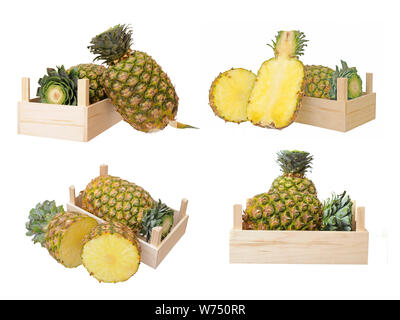 two ripe pineapples in crate isolated on white background Stock Photo