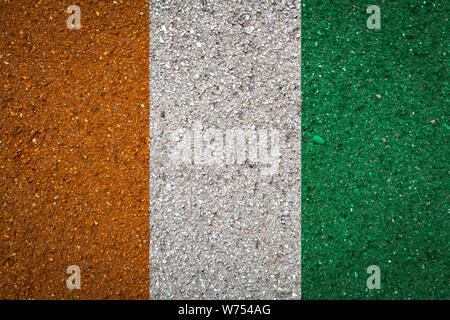 National flag of Cote d'Ivoire on a stone background.The concept of national pride and symbol of the country. Stock Photo