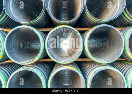 Close up of the holes of shiny metal pipes on a sunny day Stock Photo