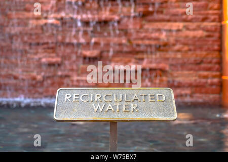 Close up of metal plate with words Recirculated Water embossed on surface Stock Photo