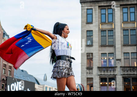 Amsterdam, Netherlands. 04th Aug, 2019. Venezuelan singer, songritten and actress Mayre Martinez is seen holding a Venezuelan flag. The official end - party where there is always a colourful collection of artists enters the stage took place at the famous Dam square in Amsterdam. This year's performances of Conchita, Mutya Buena, Netta, Paul Morris, Mayré Martinez, Channah Hewitt, etc and hosting by one of the Pride ambassadors, Amber Vineyard. Credit: SOPA Images Limited/Alamy Live News Stock Photo