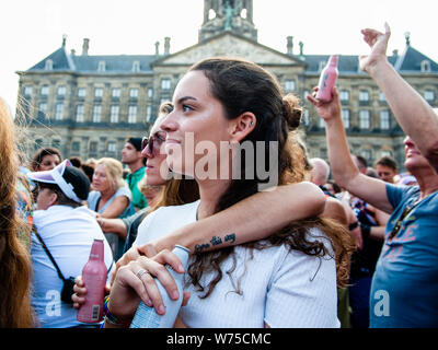 Amsterdam, Netherlands. 04th Aug, 2019. Two woman are seen hugging each other in the audience. The official end - party where there is always a colourful collection of artists enters the stage took place at the famous Dam square in Amsterdam. This year's performances of Conchita, Mutya Buena, Netta, Paul Morris, Mayré Martinez, Channah Hewitt, etc and hosting by one of the Pride ambassadors, Amber Vineyard. Credit: SOPA Images Limited/Alamy Live News Stock Photo