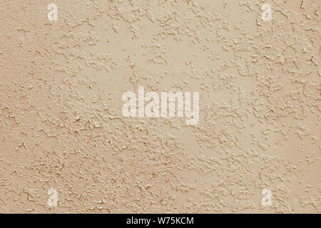 Yellow texture of peeling paint, light brown background. Dirty concrete wall. Retro effect. Empty space. Abstract beige pattern, damaged surface. Stock Photo