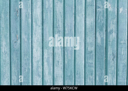 Narrow wooden planks. Gray and light blue wood vertical boards. Weathered colored old fence. Rough texture. Striped wooden backgrounds. Natural Stock Photo