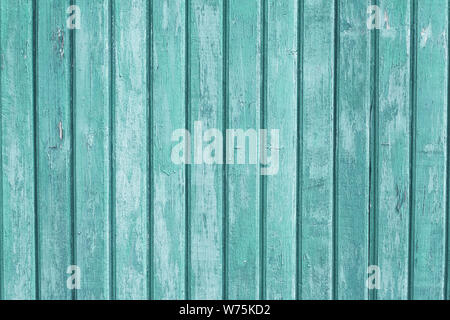 Turquoise wooden fence background. Vertical old wood planks, light green shabby surface. Oak timber wall texture. Copy space. Vintage boards. Stock Photo