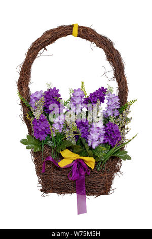 Wreath decoration background. Close-up of wreath decoration on the house door with pink and purple artificial summer flowers isolated on a white backg Stock Photo