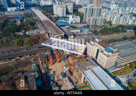 A box girder bridge rotates clockwise over a railway to dock with the Hanjiang Avenue under construction in Wuhan city, central China's Hubei province Stock Photo