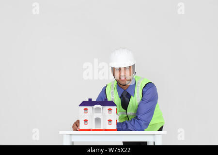 Indian architect showing model of dream home Stock Photo