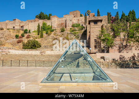 View to ancient Roman amphitheater ruins with Alcazaba fortress in background. Malaga, Andalusia, Spain Stock Photo