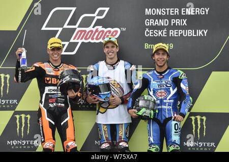 Brno, Czech Republic. 04th Aug, 2019. Road racers L-R Fabio Di Giannantonio (Italy), Alex Marquez (Spain) and Enea Bastianini (Italy) are seen on the podium during the Czech Republic motorcycle Grand Prix 2019 after Moto2 category race, in Brno Circuit, Czech Republic, on August 4, 2019. Credit: Vaclav Salek/CTK Photo/Alamy Live News Stock Photo