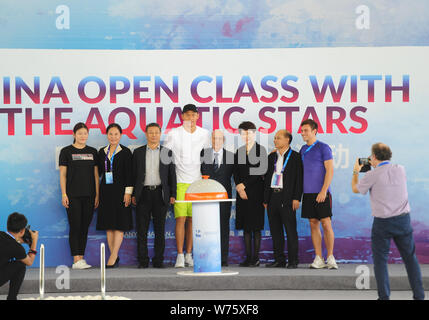 Chinese Olympic swimming champion Ye Shiwen, left, Chinese swimming star Sun Yang, tallest, and English diver Tom Daley, right, take photos during an Stock Photo