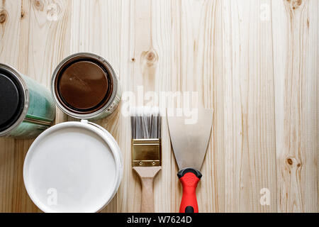 Home Repair and Building Concept. Spatula, Putty Paste,  Paint Brush,  on Textured Background. Metal spatula with plastic handle and paint brushes. Stock Photo