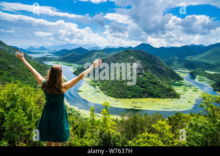 Montenegro, Beautiful young girl with long hair standing at crnojevica river water bend, pavlova strana above green valley in national park skadar lak Stock Photo