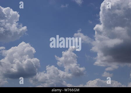 Beautiful white fluffy cloud formations on a deep blue sky Stock Photo