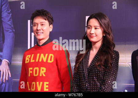 Chinese actor Feng Shaofeng, left, and actress Liu Yifei pose as they arrive on the red carpet for the premiere event of the new movie 'Hanson and the Stock Photo