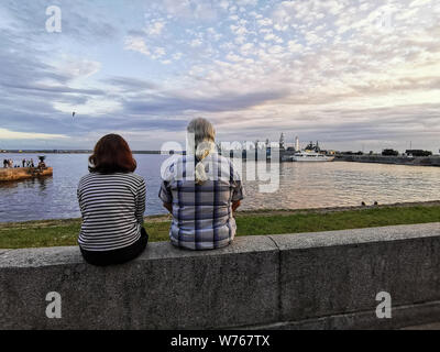 Kronstadt, Russian - July 23, 2019: people on the waterfront walk and look at the ships. view of the warships of the navy of Russia in the bay of Kron Stock Photo