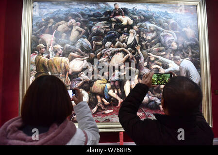 Visitors take photos of the oil painting 'Nanjing Massacre' by US-based Chinese artist Li Zijian on China's fourth National Memorial Day for Nanjing M Stock Photo