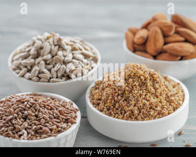 Homemade LSA mix in plate and Linseed or flax seeds, Sunflower seeds and Almonds. Traditional Australian blend of ground, source of dietary fiber, protein, omega fatty acids. Copy space for text. Stock Photo