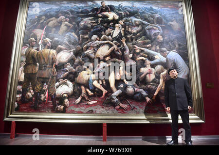 US-based Chinese artist Li Zijian is standing in front of his oil painting 'Nanjing Massacre' on China's fourth National Memorial Day for Nanjing Mass Stock Photo
