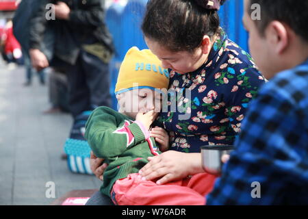 Three-year-old Uyghur boy diagnosed with rhabdomyosarcoma and his parents arrive in Guangzhou city, south China's Guangdong province, 2 December 2017. Stock Photo