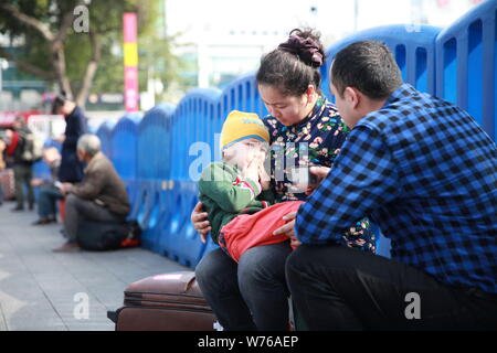 Three-year-old Uyghur boy diagnosed with rhabdomyosarcoma and his parents arrive in Guangzhou city, south China's Guangdong province, 2 December 2017. Stock Photo