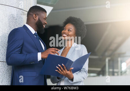 A couple of business partners smiling and making eye contact Stock Photo