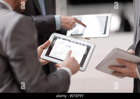 close up.businessmens discuss schedule of sales through the tab Stock Photo