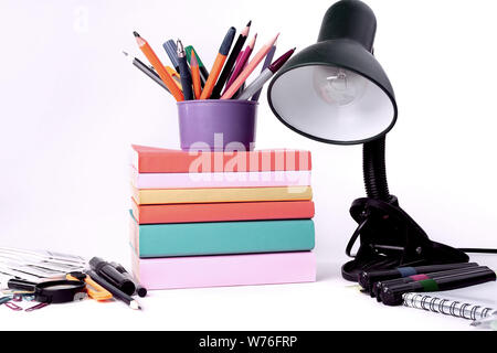 table lamp and colorful school supplies on white background .photo with copy space Stock Photo
