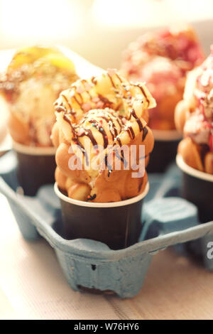 four Hong Kong waffles in cups food delivery Stock Photo