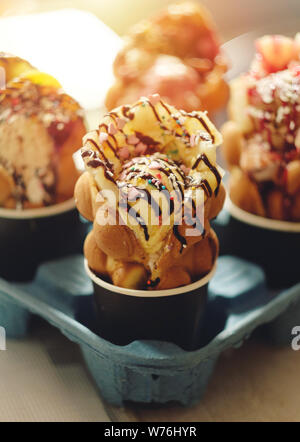 four Hong Kong waffles in cups food delivery Stock Photo