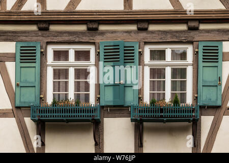 Sindelfingen, Baden Wurttemberg/Germany - May 11, 2019: Two colorful wooden windows on a traditional half-timbered house facades. Stock Photo