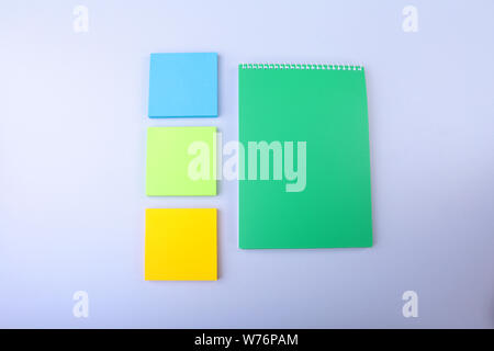 White notepad with colorful sticky reminder notes. Stock Photo