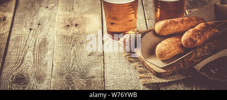 Corn dogs and beer on rustic background Stock Photo