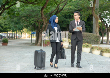 Young entrepreneurs talking outdoor, business travelling. Stock Photo