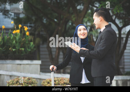 Young entrepreneurs talking outdoor, business travelling. Stock Photo