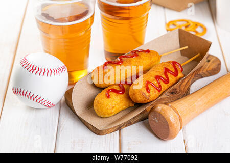 Corn dogs and beer on rustic background Stock Photo