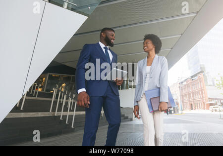 Two african american colleagues discussing new project outdoors Stock Photo