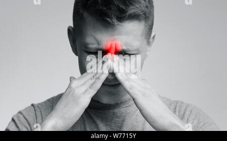 Frustrated young man suffering from sinus pressure Stock Photo