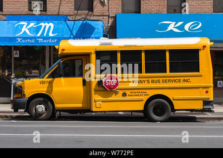 Yellow school bus, view of a school bus parked in 8th Avenue, New York City, USA. Stock Photo