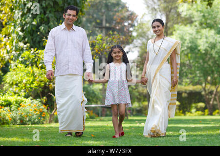 South Indian family walking together in a park Stock Photo